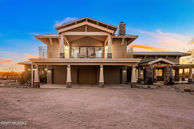 view of front of house featuring a balcony and a garage