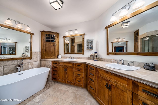 bathroom with vanity, a bathing tub, and tile walls