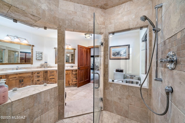 bathroom with vanity and a tile shower