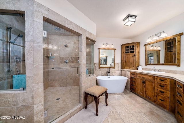 bathroom with vanity, separate shower and tub, and tile walls