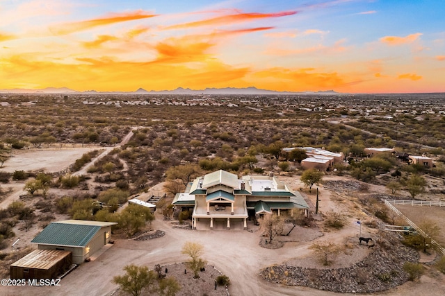 aerial view at dusk featuring a mountain view