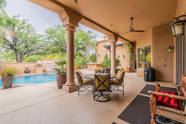 view of patio / terrace featuring ceiling fan and a fenced in pool