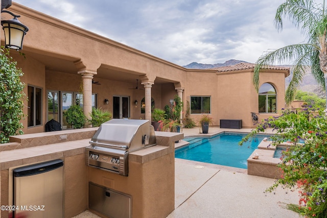 view of pool featuring a patio, ceiling fan, and area for grilling