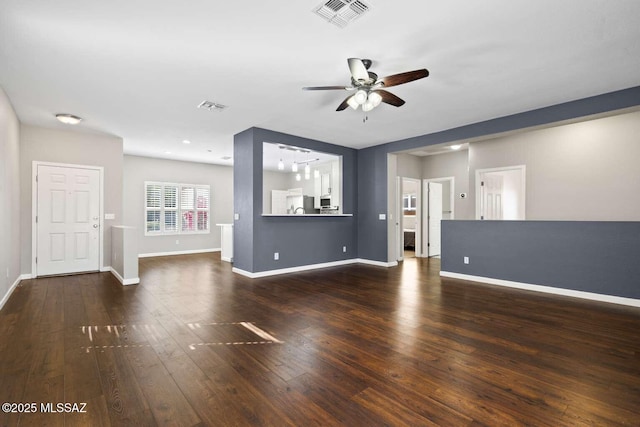 unfurnished living room featuring ceiling fan and dark hardwood / wood-style floors