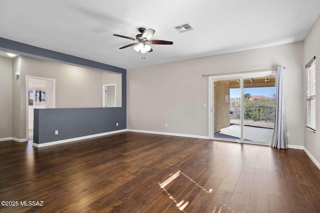 empty room with ceiling fan and dark hardwood / wood-style floors