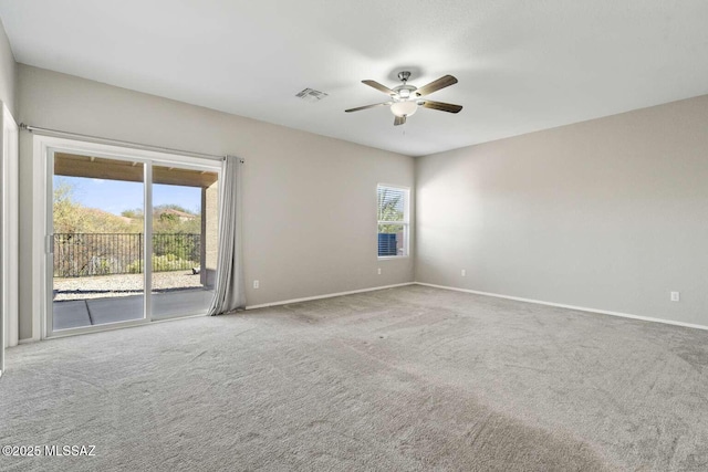 carpeted spare room with ceiling fan