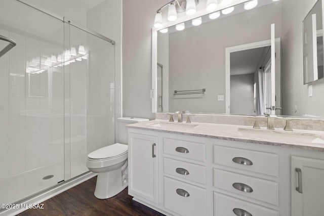 bathroom with toilet, a shower with door, wood-type flooring, and vanity