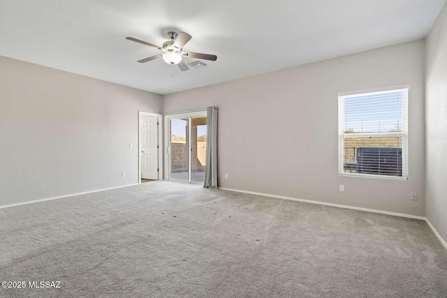 carpeted empty room featuring ceiling fan