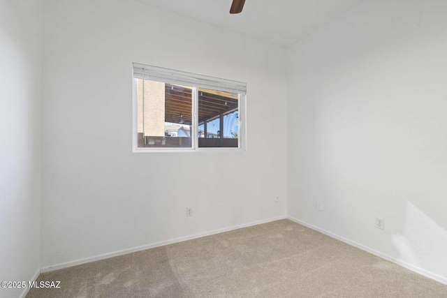 spare room with light colored carpet and ceiling fan