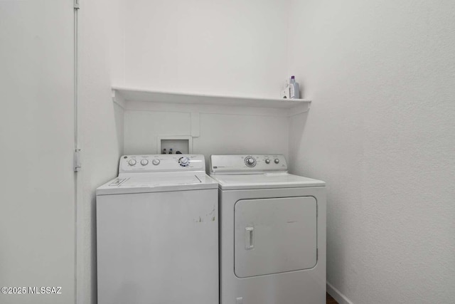 washroom featuring washer and dryer