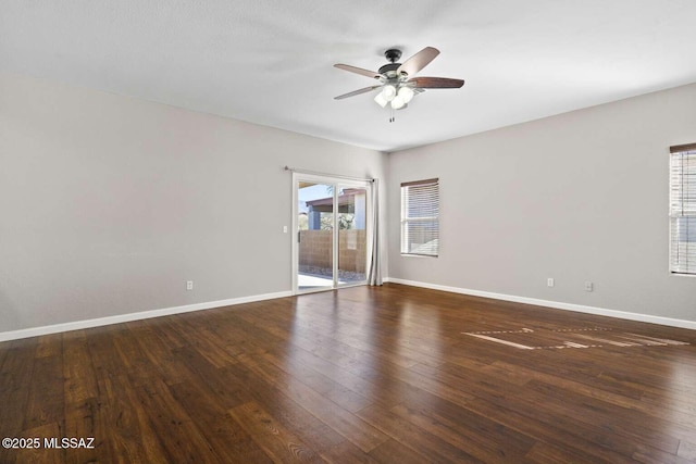 spare room featuring ceiling fan and dark hardwood / wood-style flooring