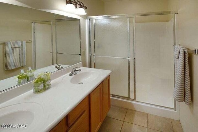 bathroom with vanity, an enclosed shower, and tile patterned floors