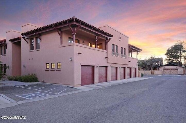 outdoor building at dusk with a garage