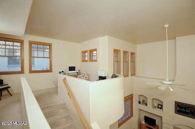 carpeted living room featuring ceiling fan