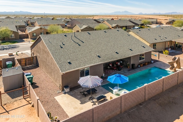 view of swimming pool featuring a mountain view and a patio