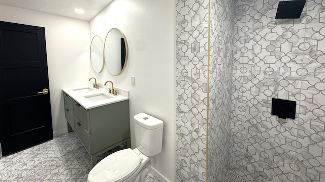 bathroom with toilet, a shower, vanity, and tile patterned flooring