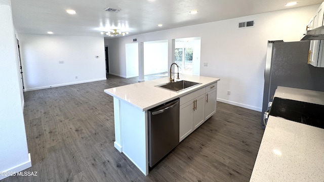 kitchen featuring light stone counters, stainless steel dishwasher, an island with sink, white cabinets, and sink