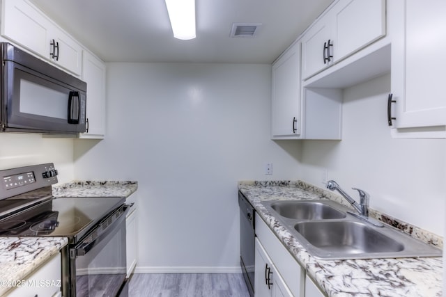 kitchen with sink, white cabinetry, and black appliances