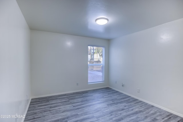 spare room featuring wood-type flooring