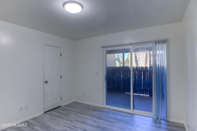 spare room with hardwood / wood-style flooring