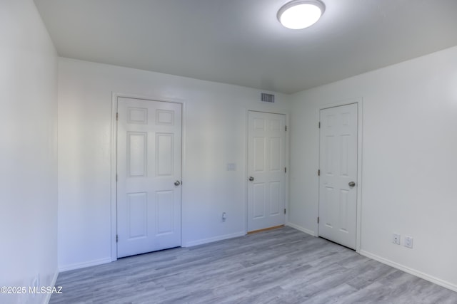 unfurnished bedroom featuring light wood-type flooring