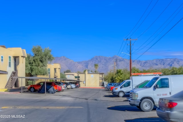 view of vehicle parking featuring a mountain view