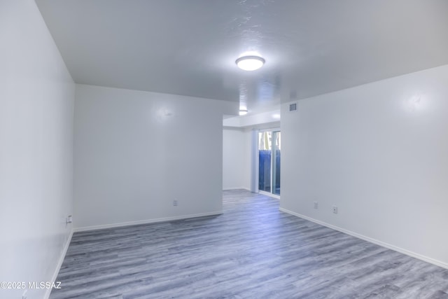 unfurnished room with hardwood / wood-style flooring