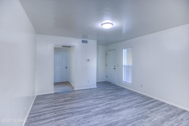 spare room featuring light hardwood / wood-style floors