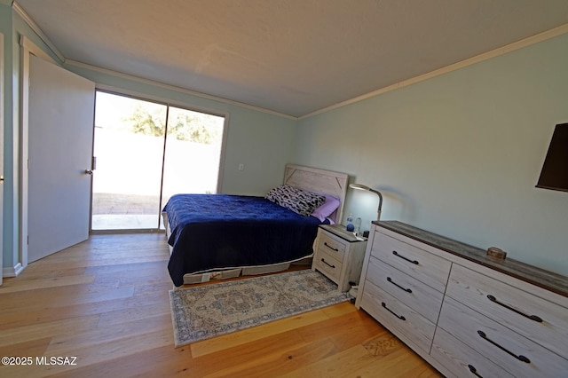 bedroom with access to exterior, light hardwood / wood-style floors, and crown molding