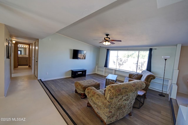 living room featuring vaulted ceiling, hardwood / wood-style flooring, ceiling fan, and crown molding