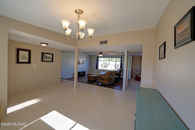 interior space featuring ceiling fan with notable chandelier and concrete floors