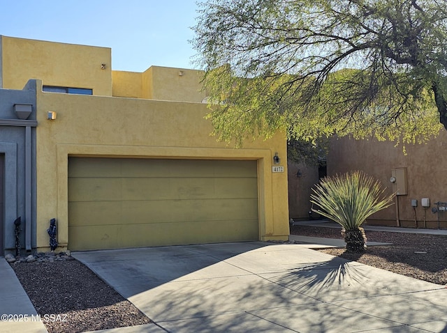 southwest-style home with a garage