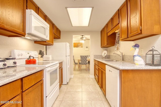 kitchen featuring ceiling fan, light tile patterned floors, sink, and white appliances