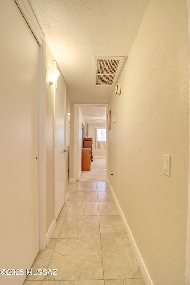 corridor with a textured ceiling