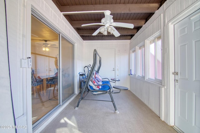 sunroom / solarium with ceiling fan, beam ceiling, and wood ceiling