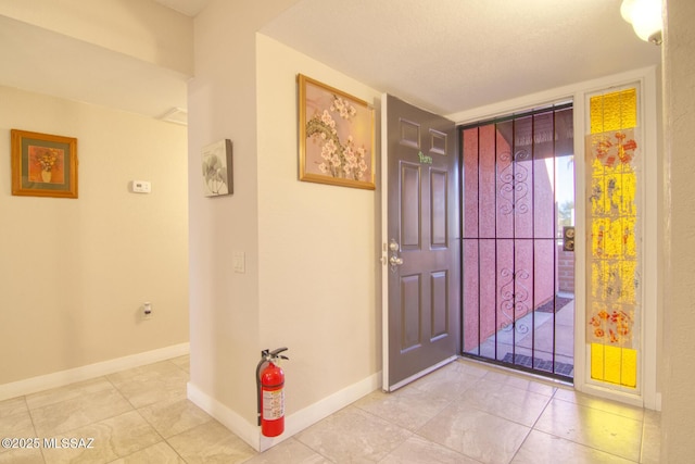 entryway with light tile patterned floors