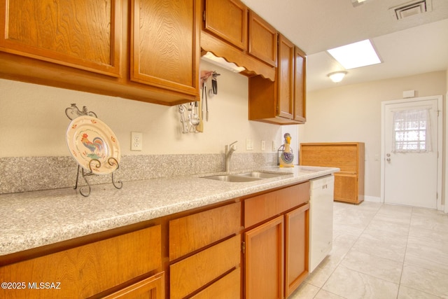 kitchen featuring sink, light tile patterned floors, and dishwasher