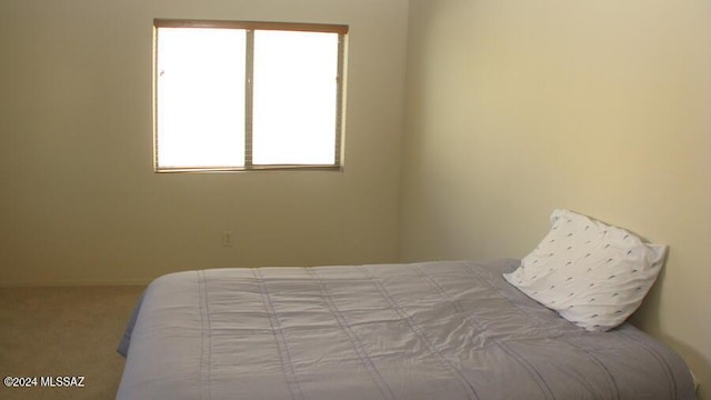 bedroom featuring light carpet