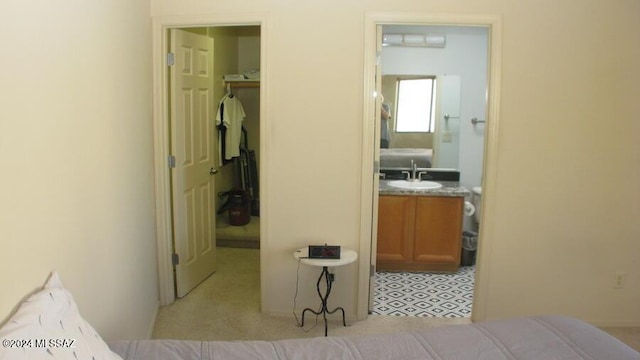 bedroom featuring sink and a closet