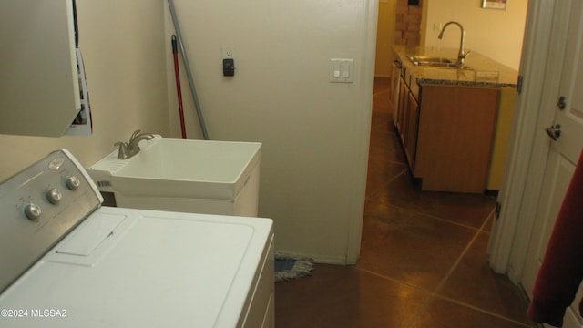 washroom with sink and dark tile patterned flooring