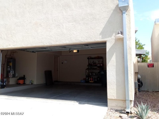 garage featuring a garage door opener and water heater