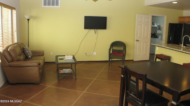 tiled living room featuring sink