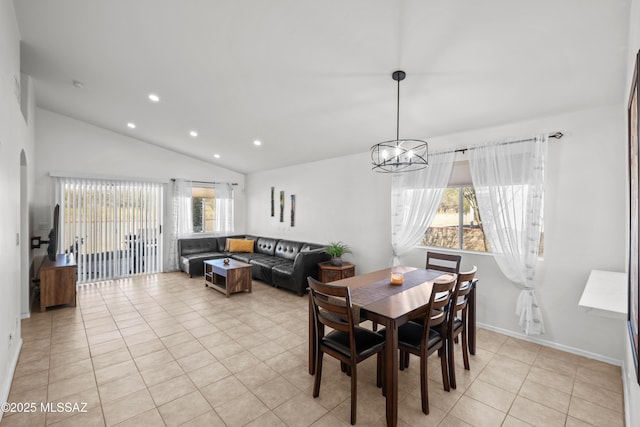 dining room featuring vaulted ceiling, light tile patterned flooring, and a chandelier