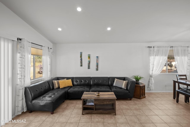 tiled living room featuring a healthy amount of sunlight and lofted ceiling