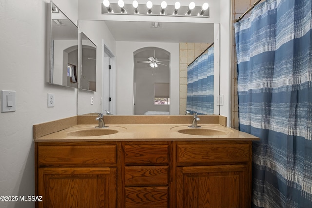 bathroom featuring ceiling fan, vanity, and curtained shower