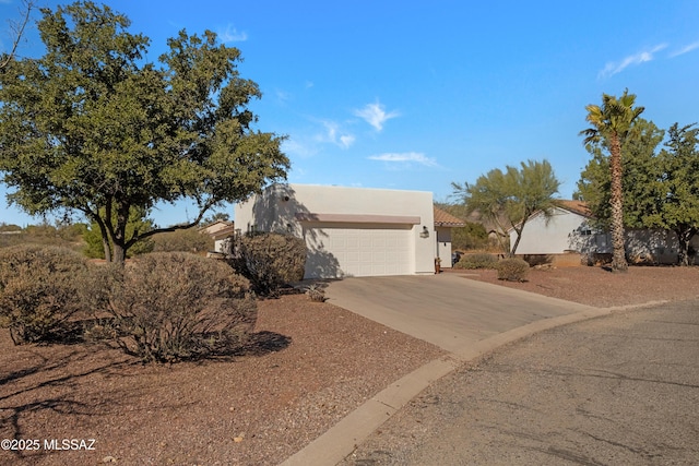 pueblo-style house featuring a garage