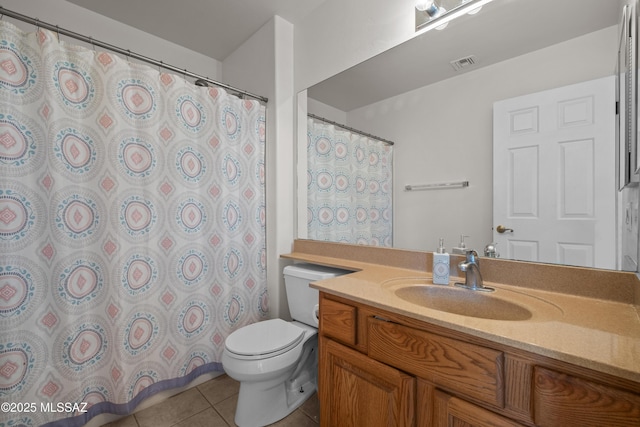 bathroom featuring toilet, tile patterned floors, and vanity