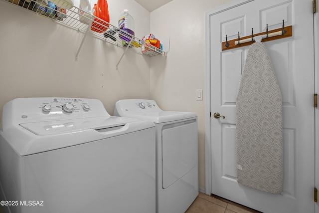 washroom with washer and clothes dryer and light tile patterned flooring