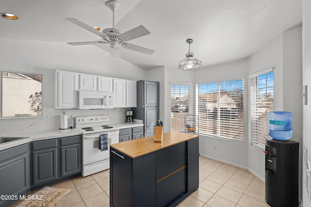 kitchen with light tile patterned floors, decorative backsplash, white cabinetry, and white appliances