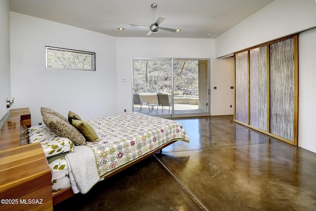 bedroom with access to exterior and concrete floors